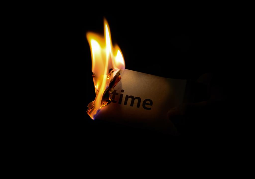 Fire burning paper with the word time