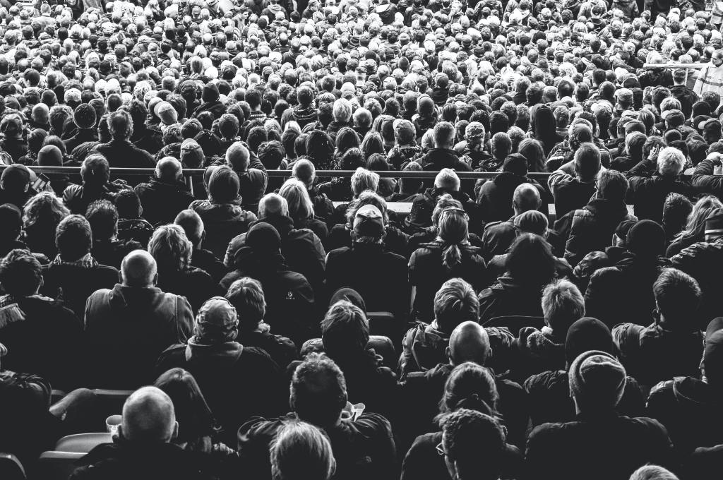 Black and White photo of the backs of a large crowd of people