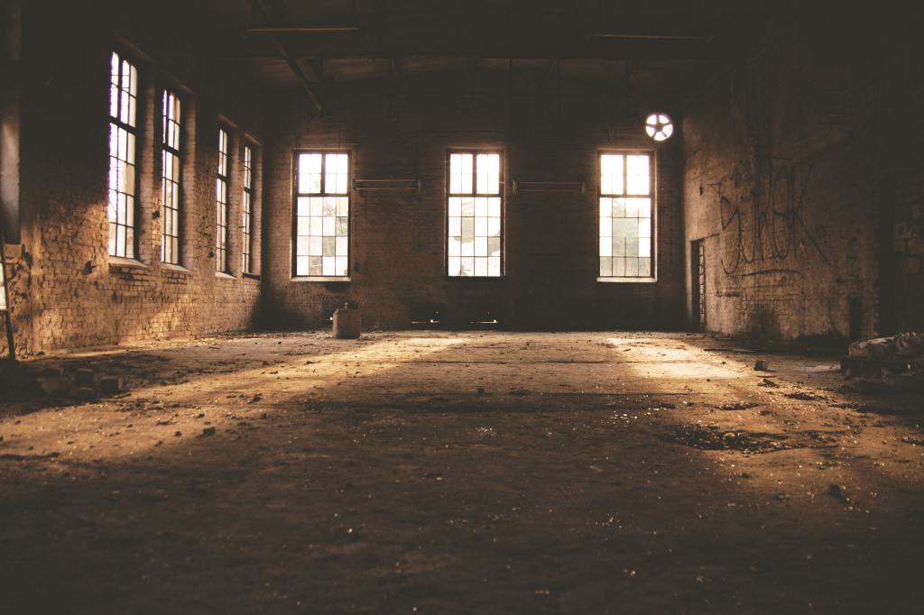 photo of an empty warehouse room with dirty floor