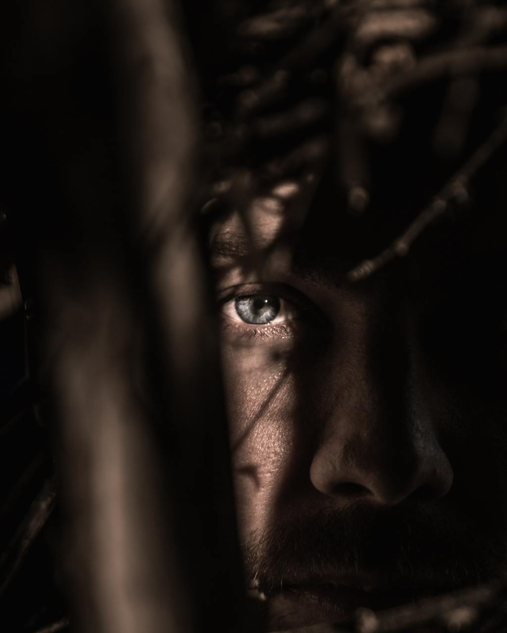 close-up photo of a man's eye in shadows
