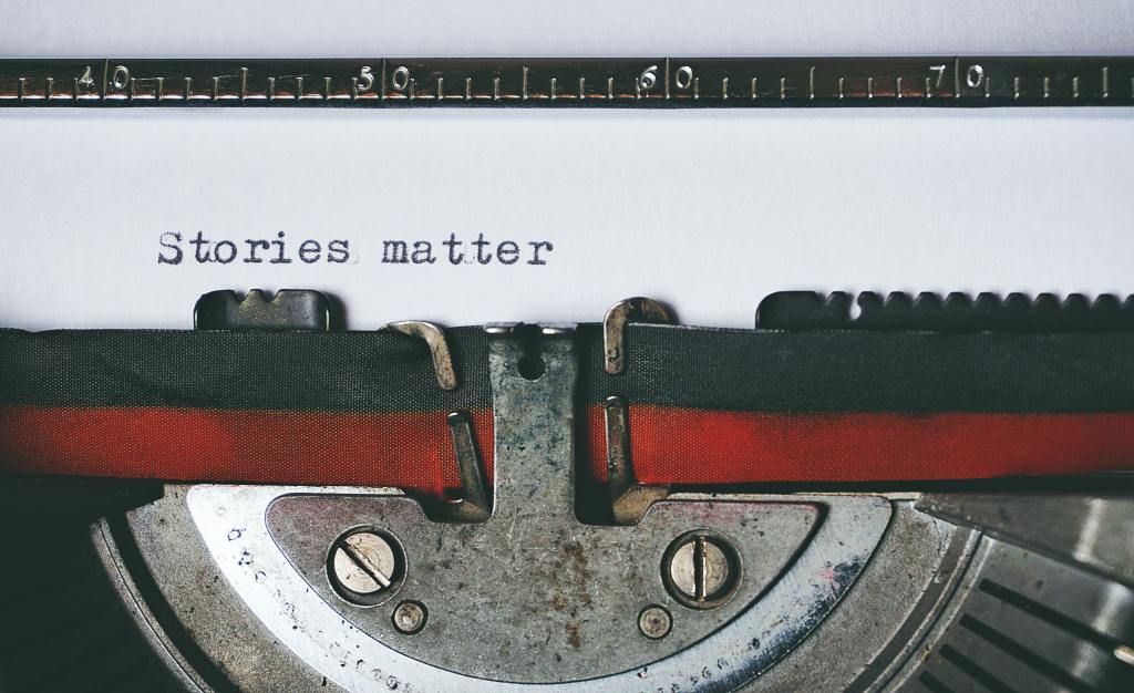 photo of typewriter close-up with words typed on paper