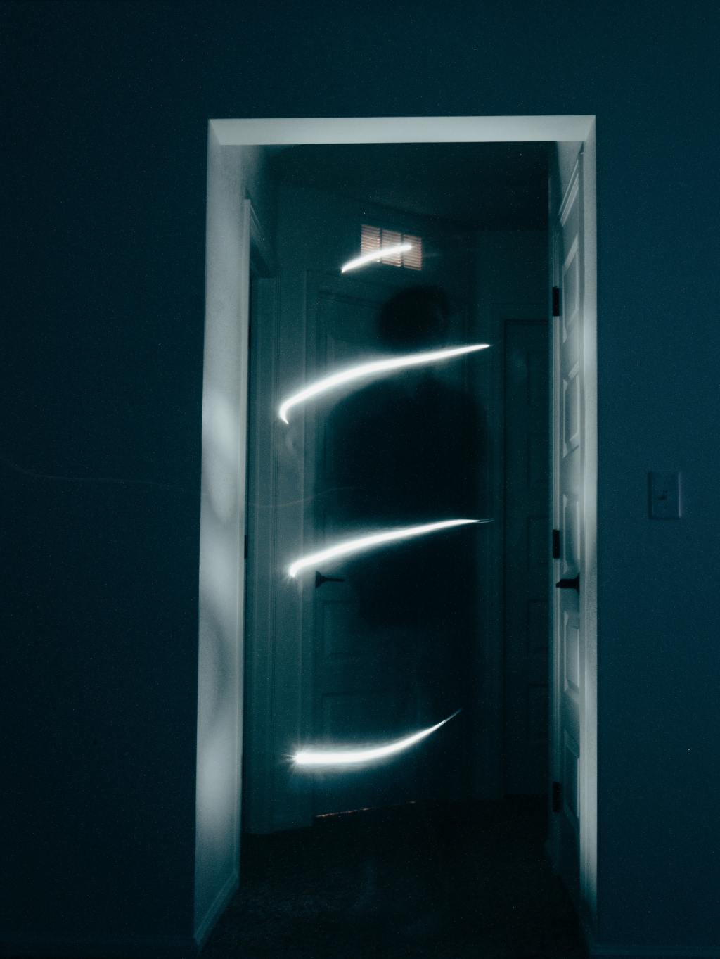 Photograph of a dark and scary hallway with a figure