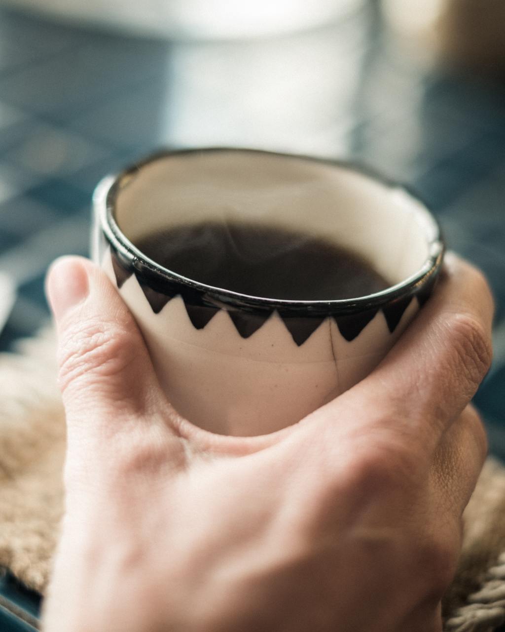 Hand holding coffee cup