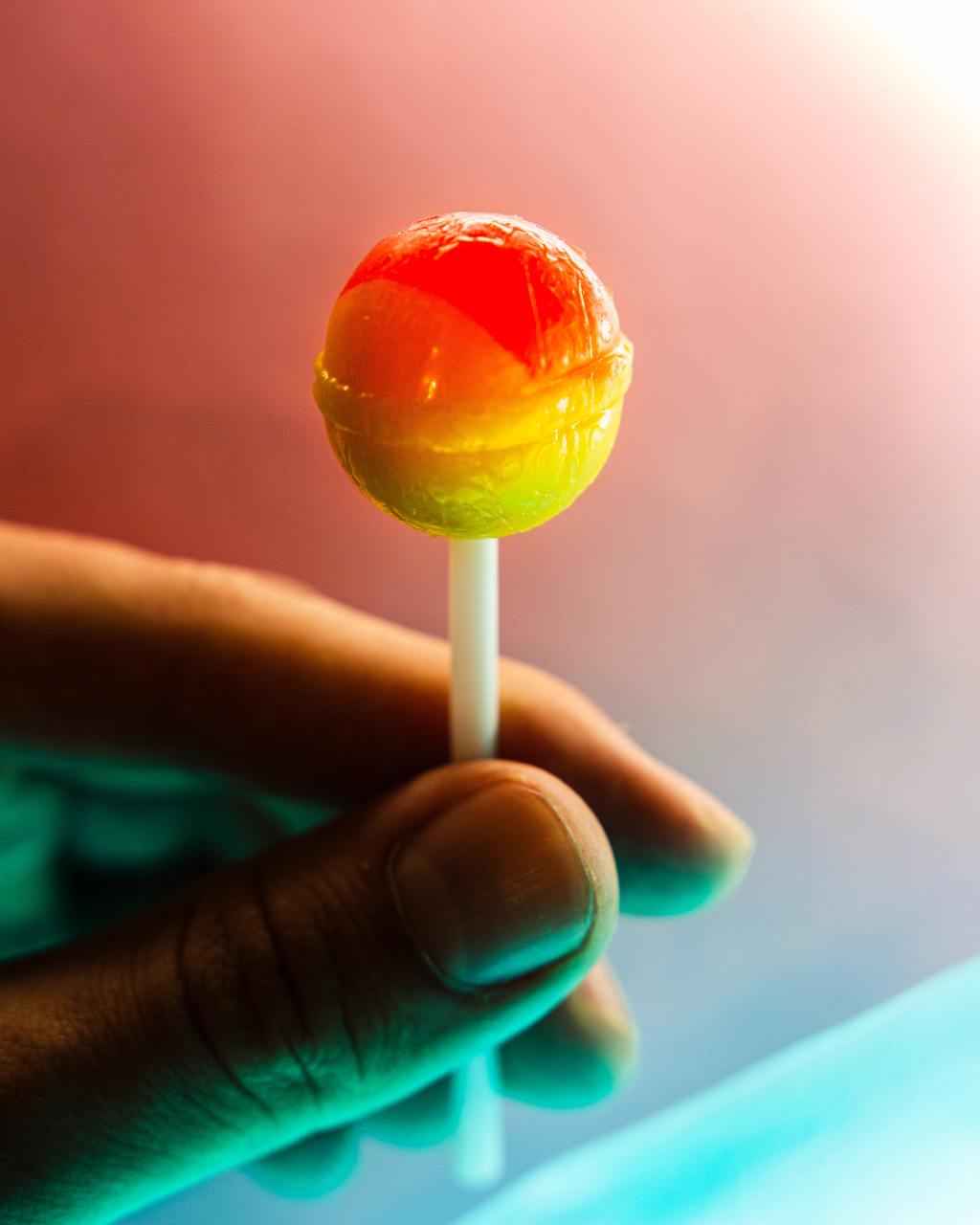 Hand Holding a Red Lollipop