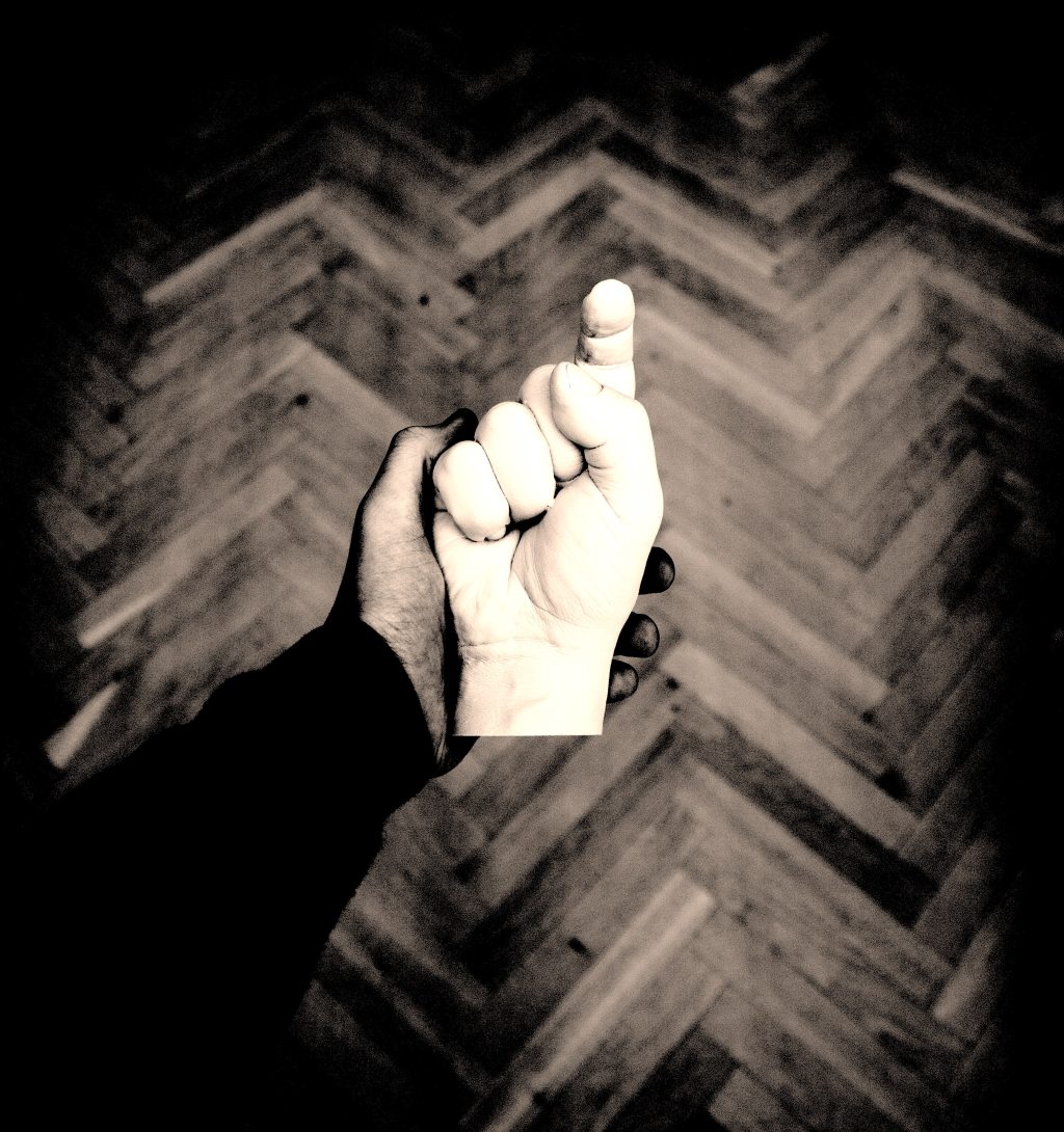 A hand holding a sculpture of a hand