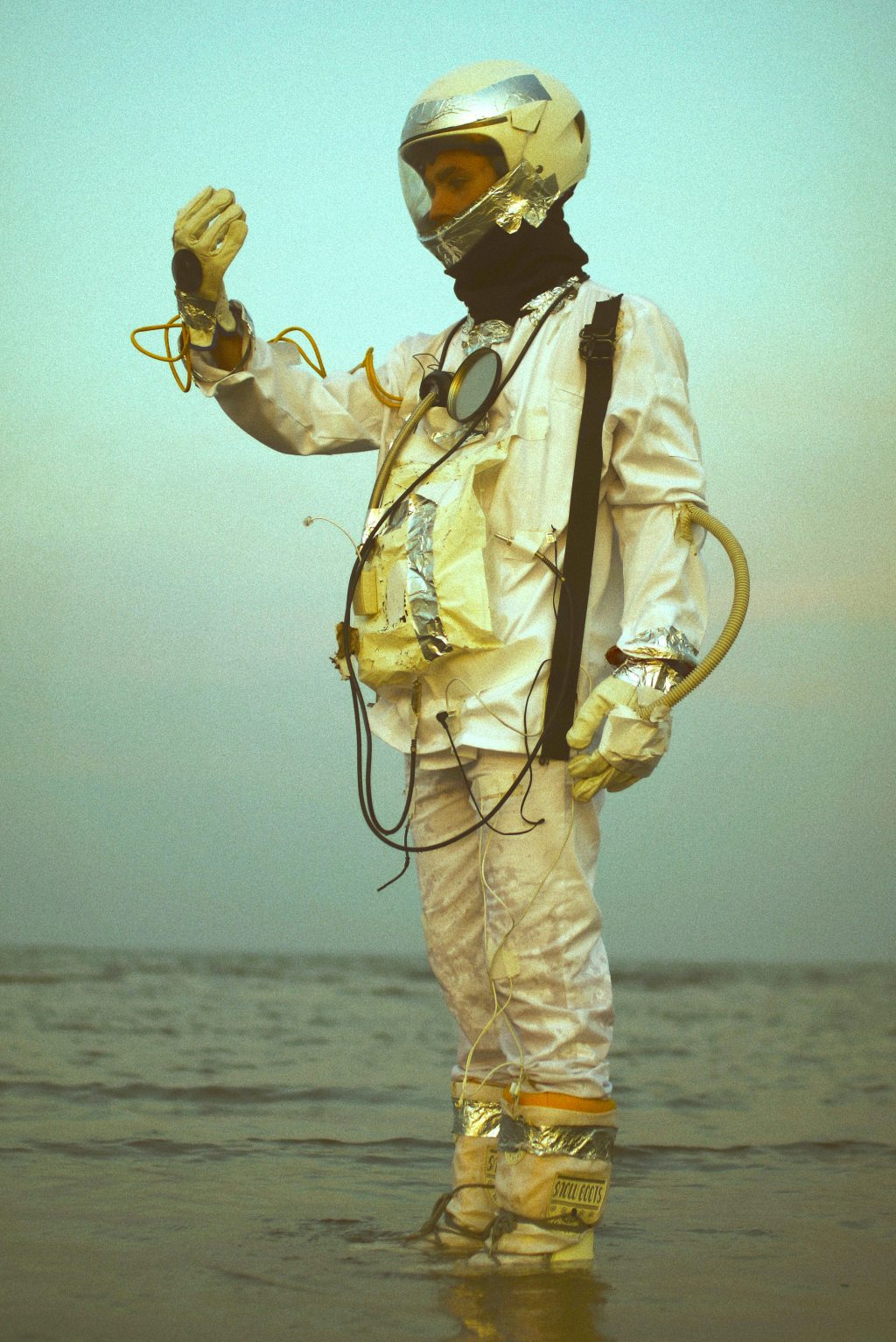 man in weird astronaut suit standing in water
