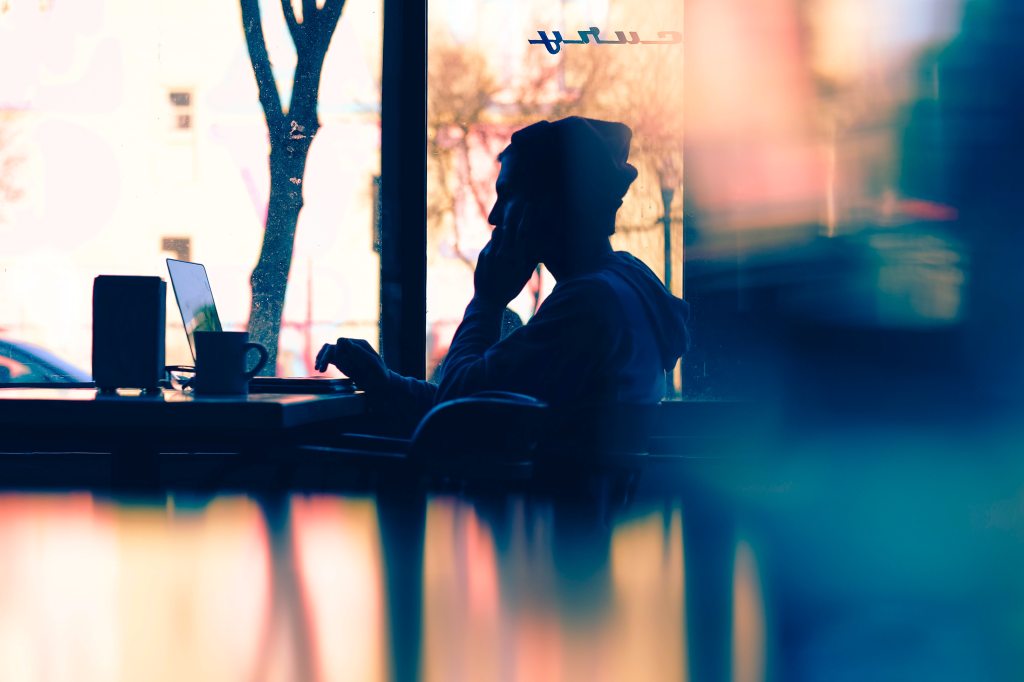 sitting at computer in coffee shop