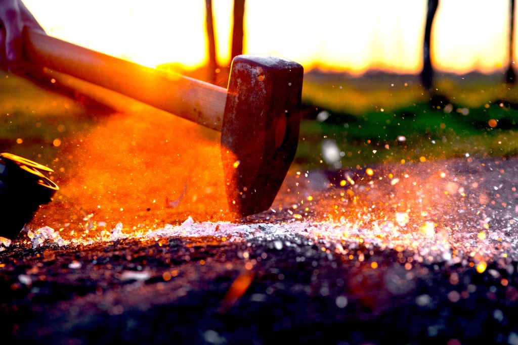 sledge hammer striking the ground