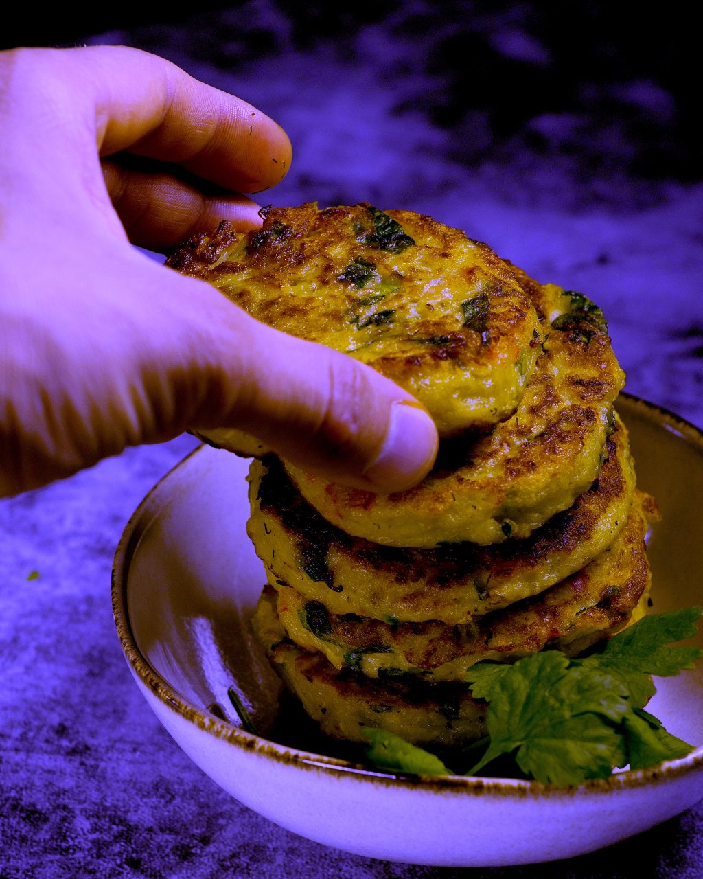 Hand reaching for fritters